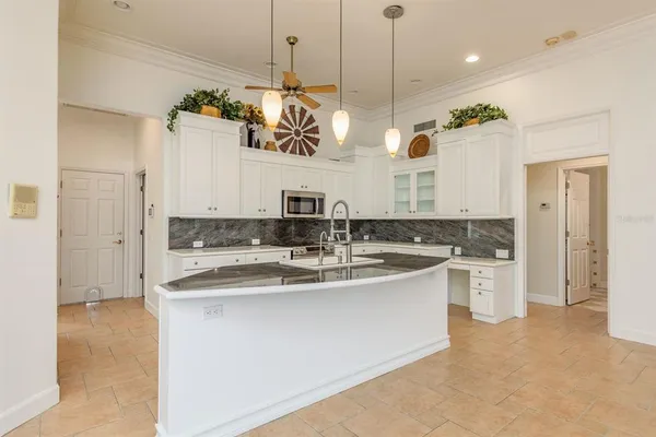 a kitchen with stainless steel appliances granite countertop a sink a stove and a refrigerator