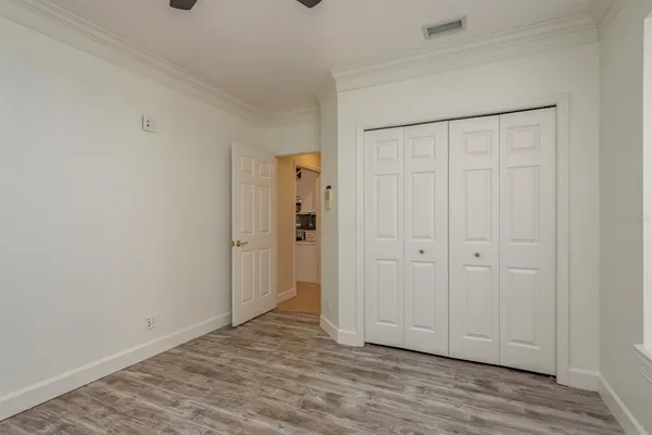 a view of a livingroom with wooden floor and a large window