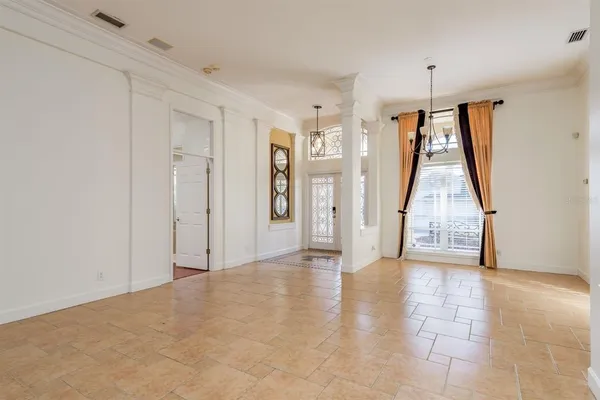 a view of a livingroom with a fireplace a ceiling fan a kitchen and a sink