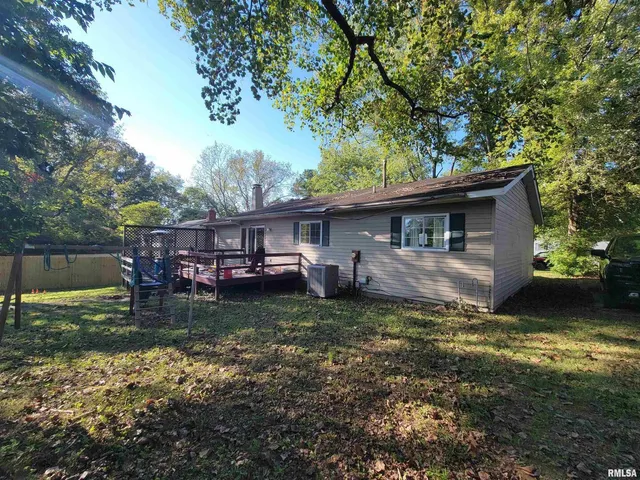 a backyard of a house with yard barbeque oven and outdoor seating