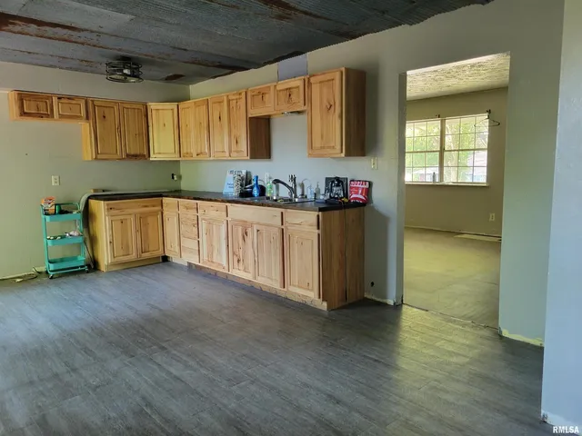 a kitchen with granite countertop wooden cabinets and a granite counter tops