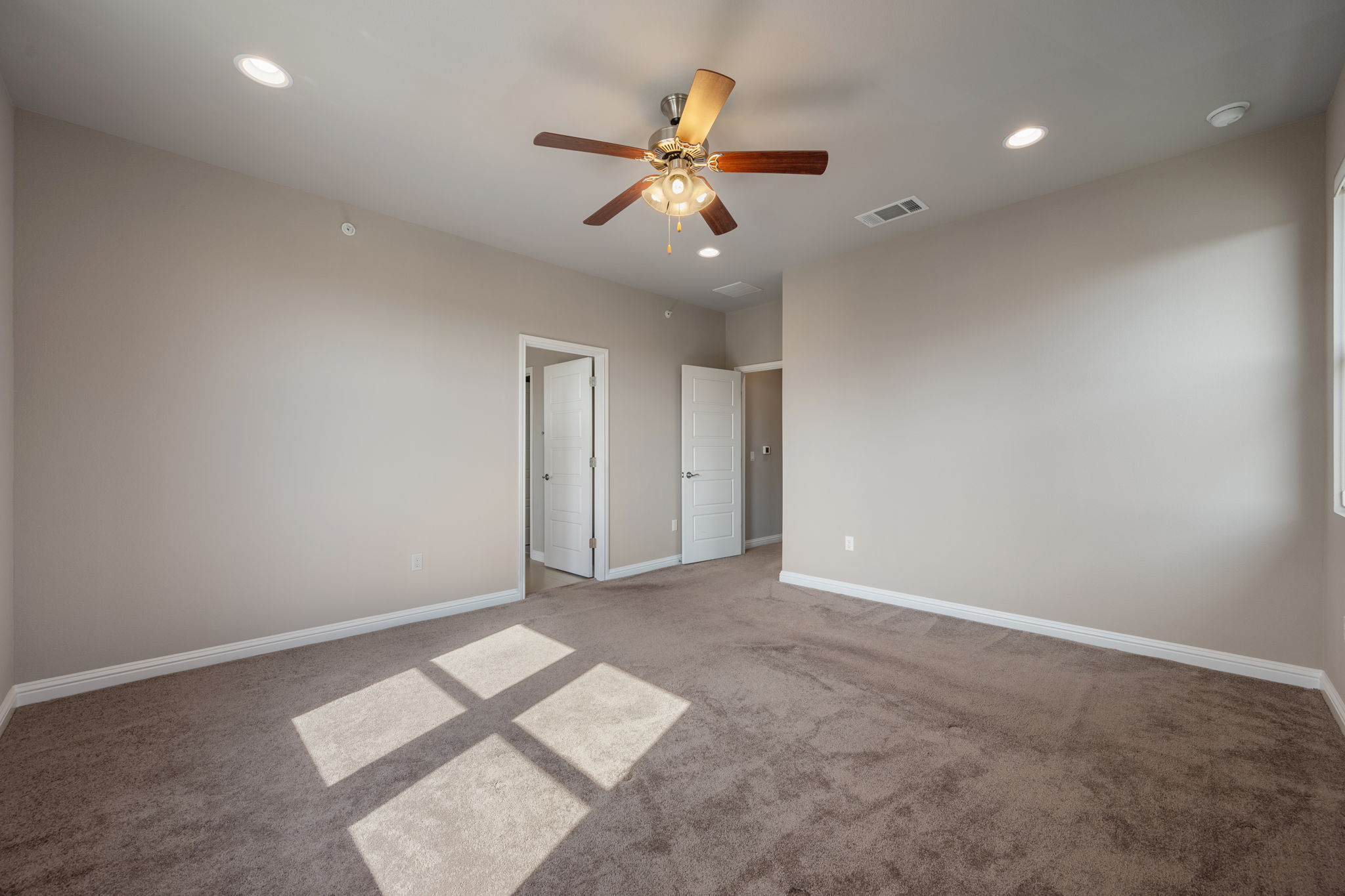 6814 East Riverside Drive, Unit 55 Austin, TX 78741 - Photo 18 of 31 Unfurnished bedroom featuring recessed lighting, carpet, and ceiling fan