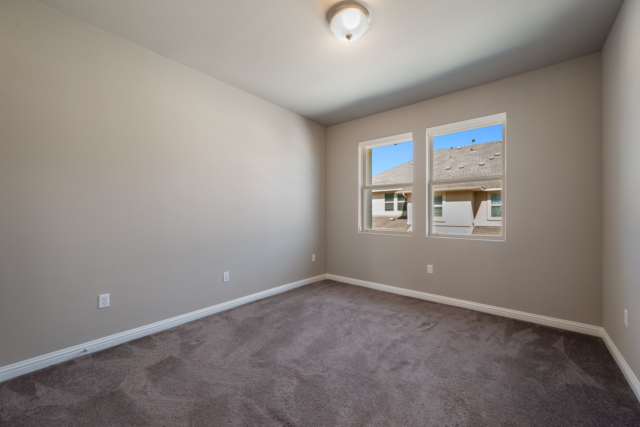 6814 East Riverside Drive, Unit 55 Austin, TX 78741 - Photo 23 of 31 Spare room featuring carpet and baseboards