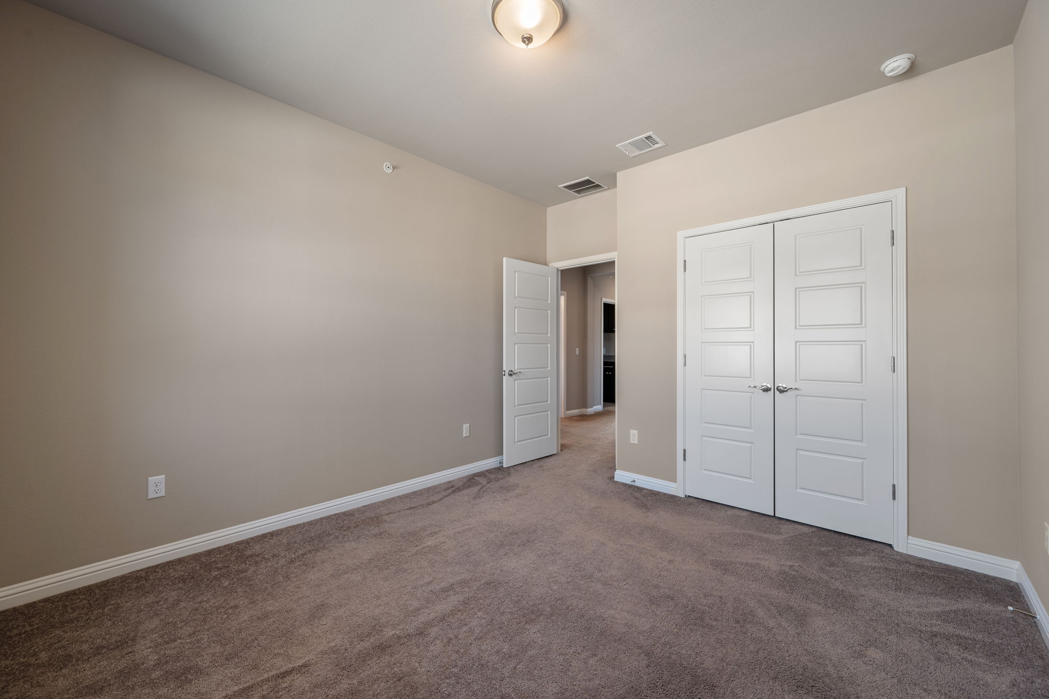 6814 East Riverside Drive, Unit 55 Austin, TX 78741 - Photo 24 of 31 Unfurnished bedroom with carpet and a closet