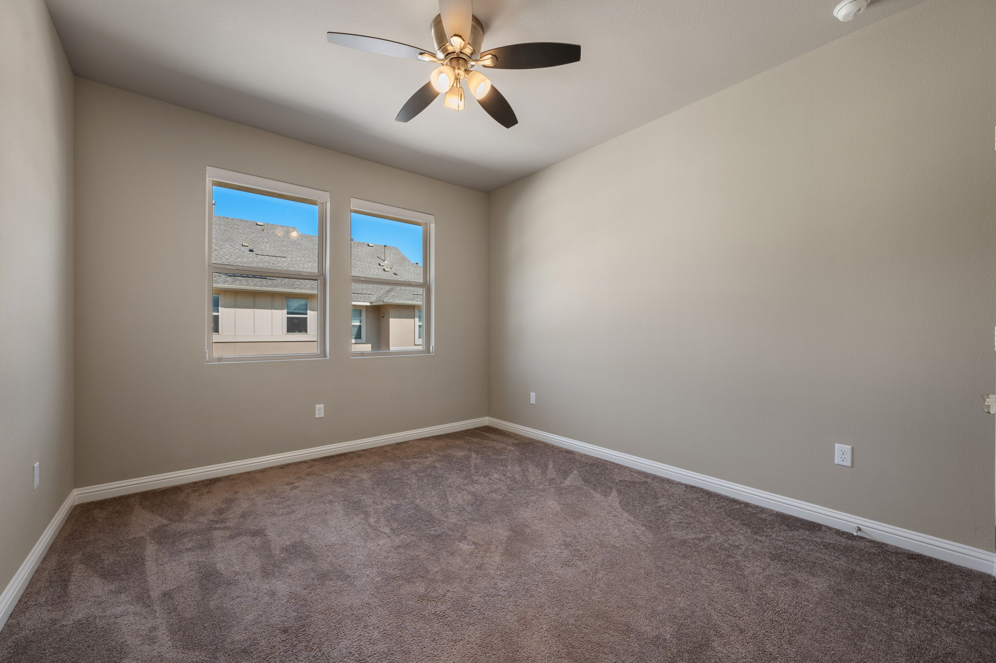6814 East Riverside Drive, Unit 55 Austin, TX 78741 - Photo 26 of 31 Carpeted empty room with baseboards and a ceiling fan