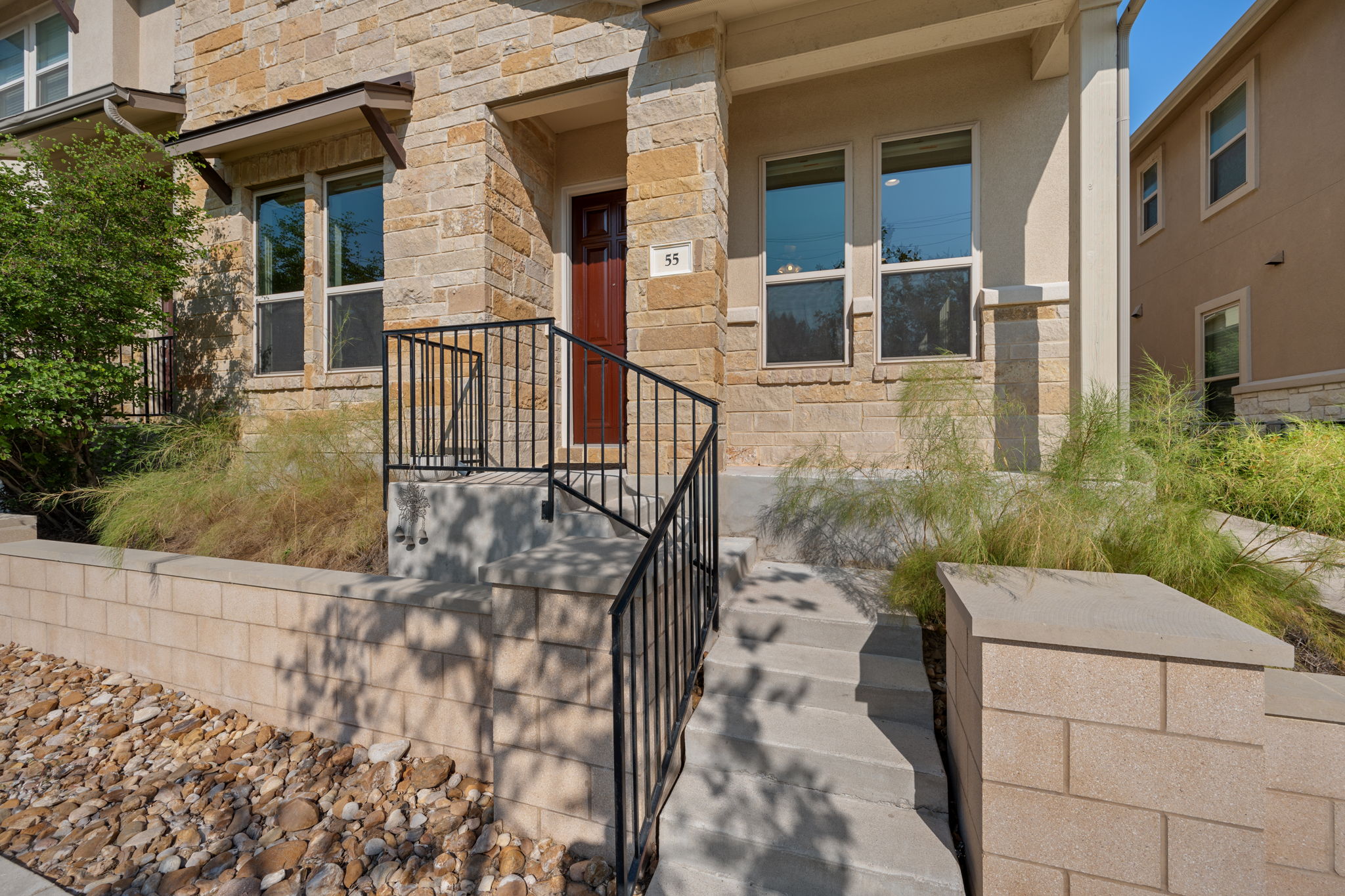 6814 East Riverside Drive, Unit 55 Austin, TX 78741 - Photo 3 of 31 View of exterior entry featuring stone siding and stucco siding