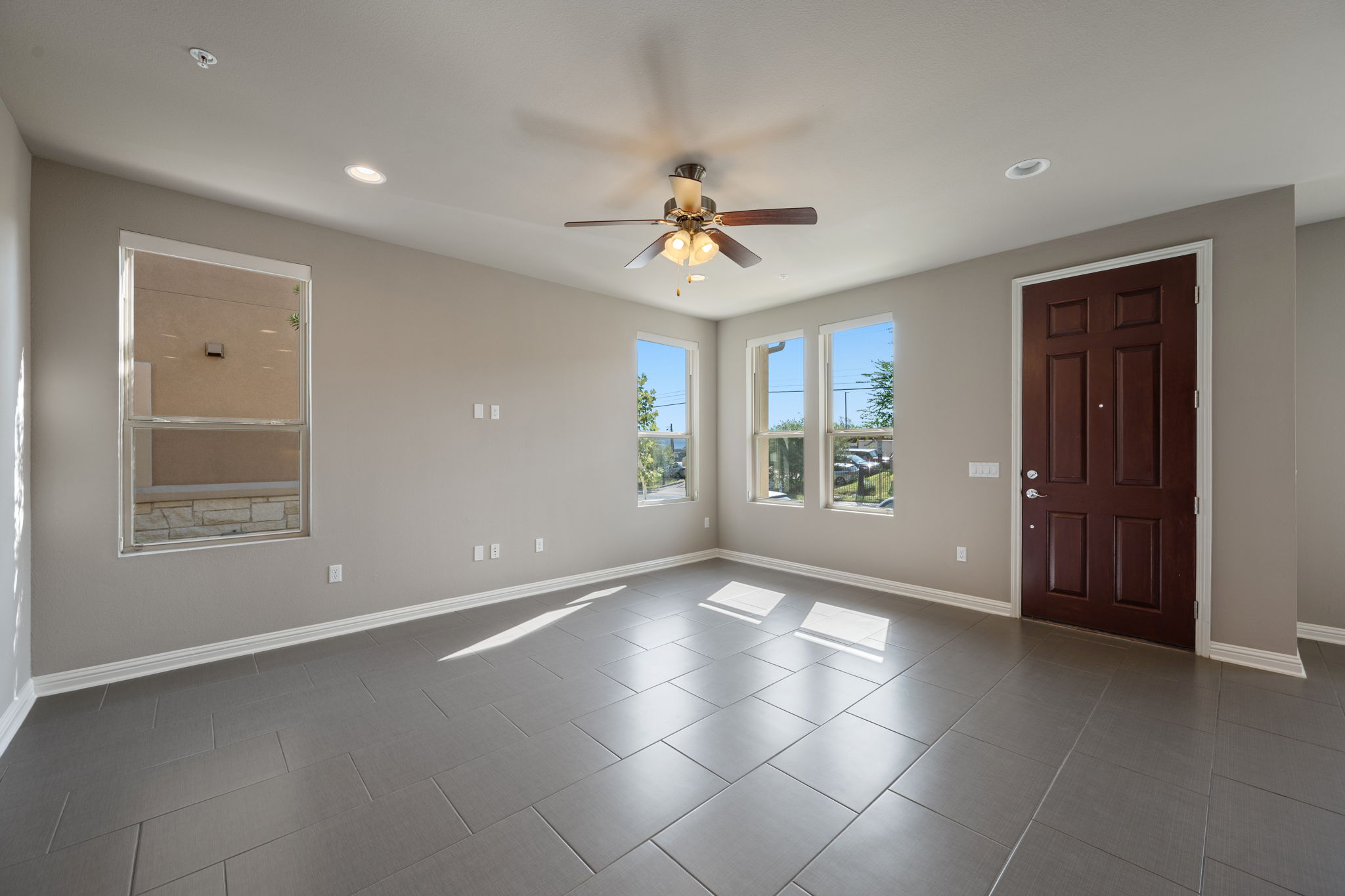 6814 East Riverside Drive, Unit 55 Austin, TX 78741 - Photo 5 of 31 Spare room featuring dark tile patterned floors, ceiling fan, and recessed lighting
