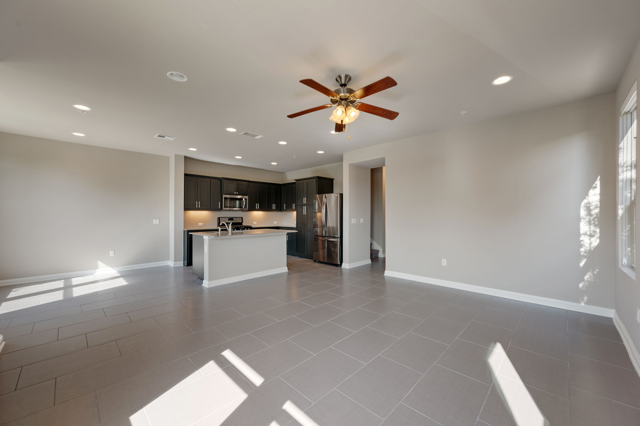 6814 East Riverside Drive, Unit 55 Austin, TX 78741 - Photo 7 of 31 Unfurnished living room with recessed lighting, ceiling fan, and light tile patterned flooring