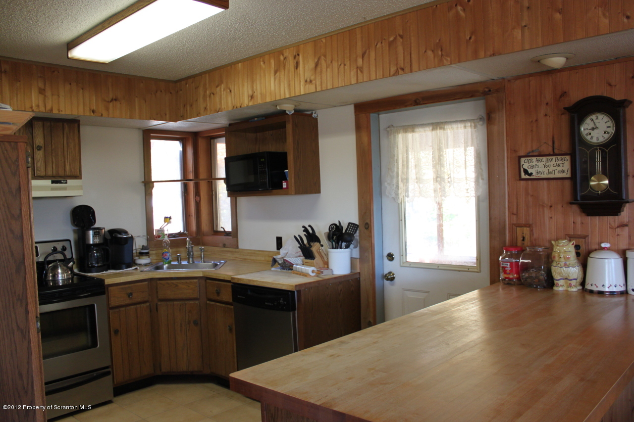 190 North Barnes Road Moscow, PA 18444 - Photo 3 of 25 a kitchen with a sink a stove and cabinets