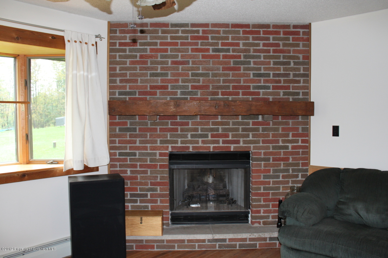 190 North Barnes Road Moscow, PA 18444 - Photo 4 of 25 a living room with furniture and a fireplace