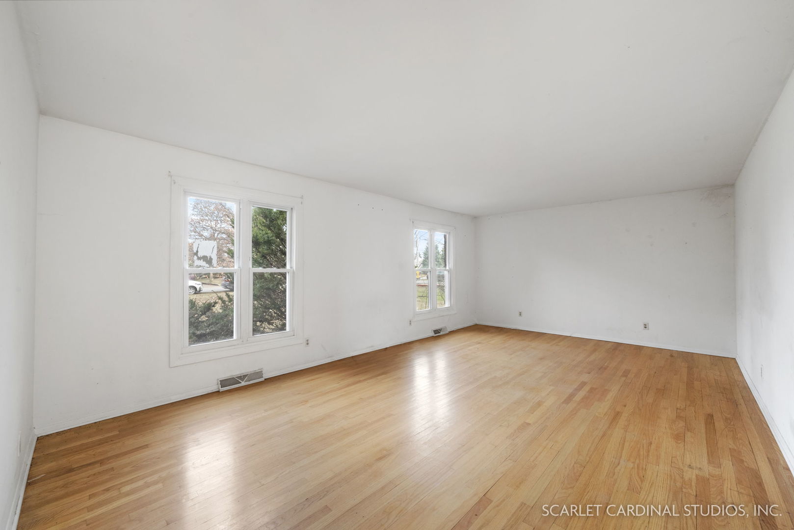 2151 Sheffer Road Aurora, IL 60502 - Photo 3 of 16 a view of an empty room with wooden floor and a window