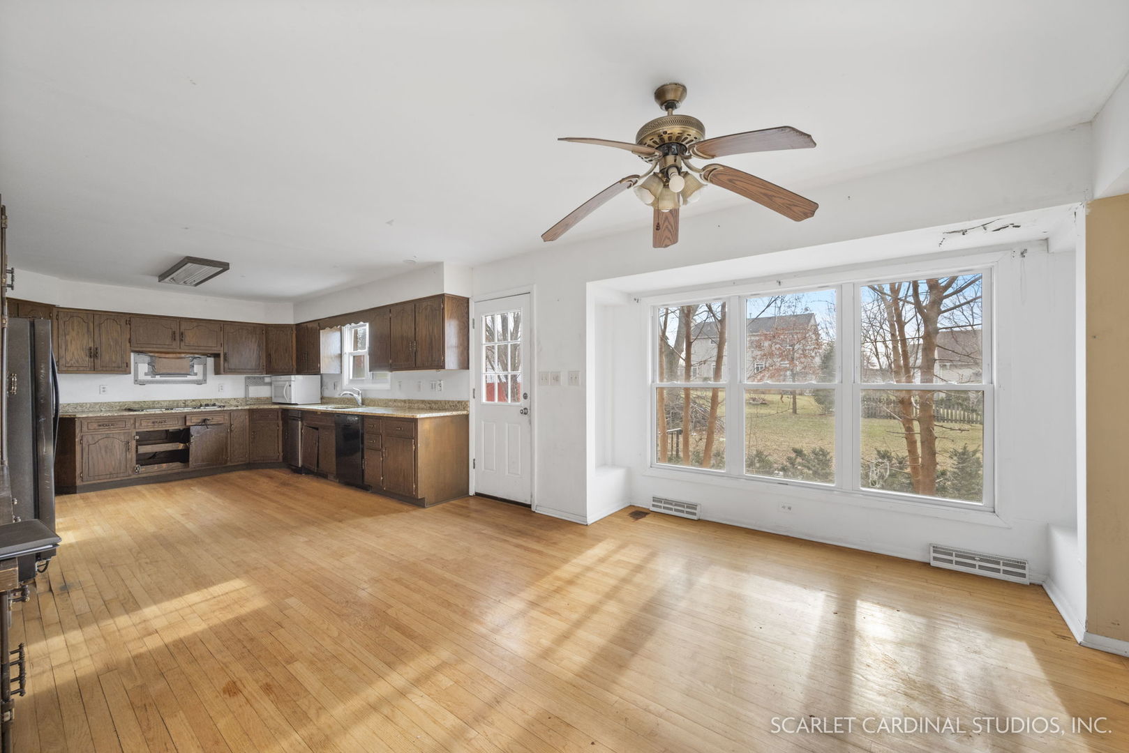 2151 Sheffer Road Aurora, IL 60502 - Photo 4 of 16 a view of a kitchen with a stove cabinets a ceiling fan and front door