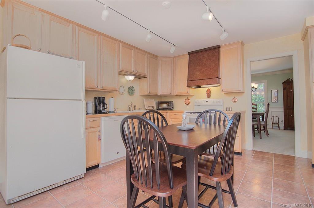 3001 Planters Ridge Road Charlotte, NC 28270 - Photo 13 of 24 a kitchen with granite countertop a dining table chairs and a refrigerator