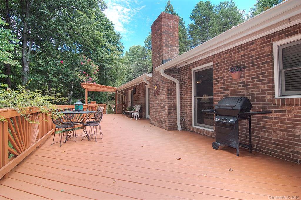 3001 Planters Ridge Road Charlotte, NC 28270 - Photo 6 of 24 a backyard of a house with barbeque oven and outdoor seating