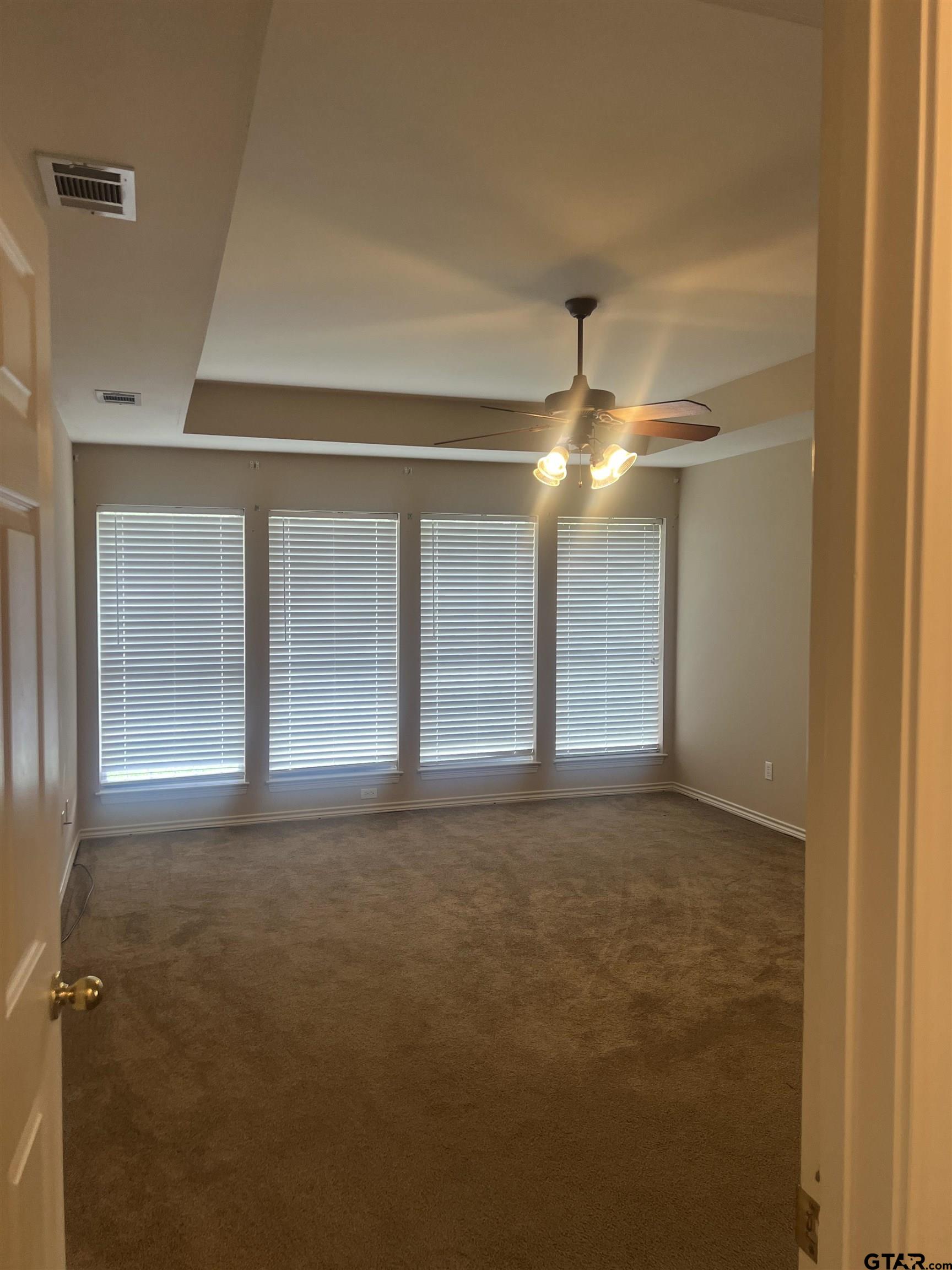 1805 Oak Ridge Street Hideaway, TX 75771 - Photo 8 of 15 a view of empty room with window and chandelier fan