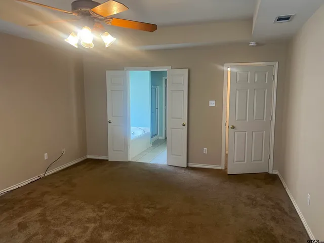 an empty room with closet area