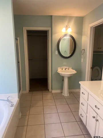 a bathroom with a sink a mirror and a mirror