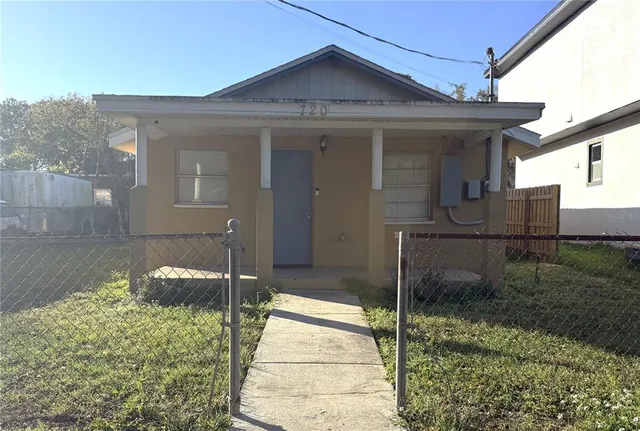 a view of a brick house with a large window