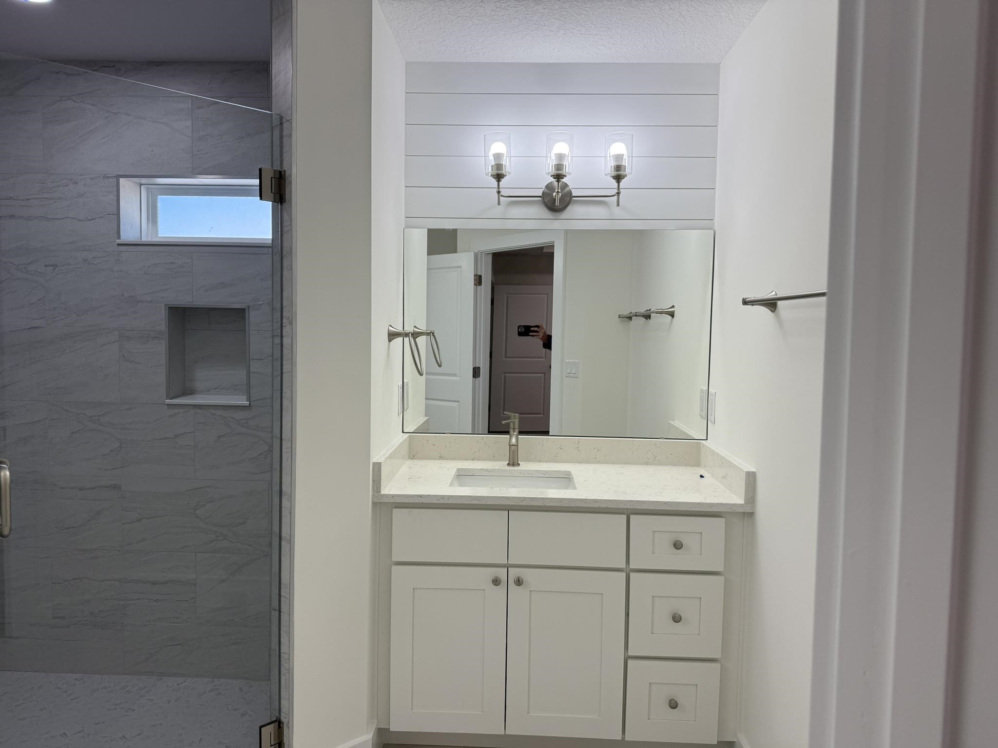 611 Queen Road St. Augustine, FL 32086 - Photo 8 of 17 Bathroom featuring vanity, quartz counters, his and her sink, shower, and recessed lighting