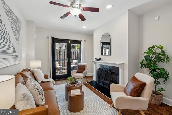 a living room with furniture and a fireplace