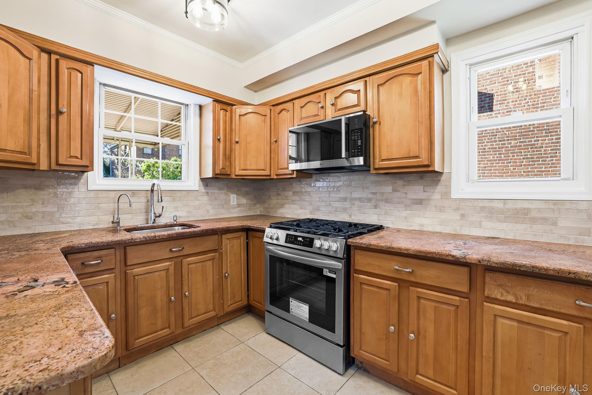2015 Tenbroeck Avenue Bronx, NY 10461 - Photo 14 of 50 a kitchen with stainless steel appliances granite countertop a stove sink and microwave