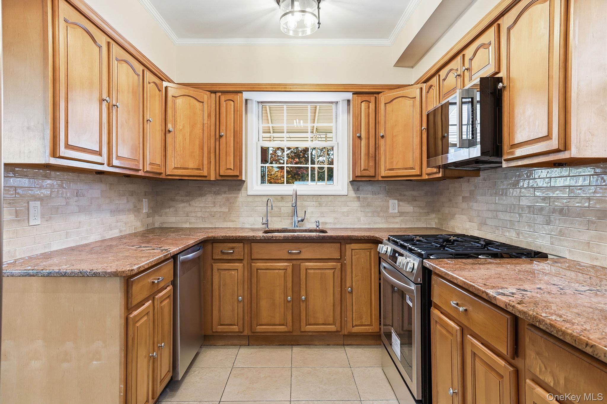 2015 Tenbroeck Avenue Bronx, NY 10461 - Photo 15 of 50 a kitchen with stainless steel appliances granite countertop a sink stove and cabinets