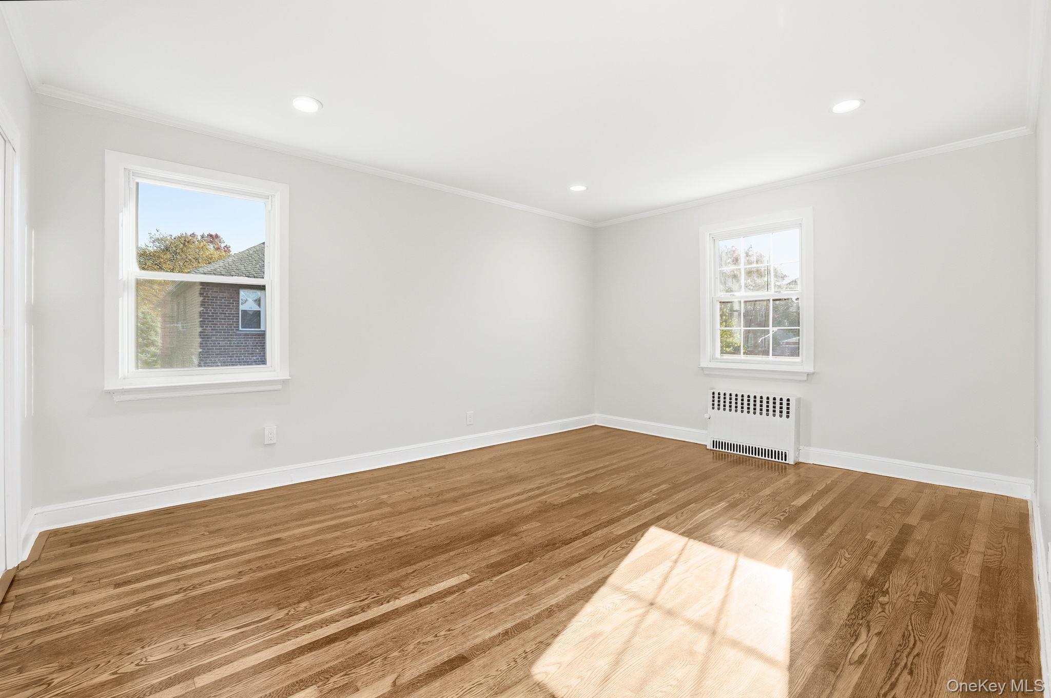 2015 Tenbroeck Avenue Bronx, NY 10461 - Photo 22 of 50 a view of an empty room with wooden floor and a window