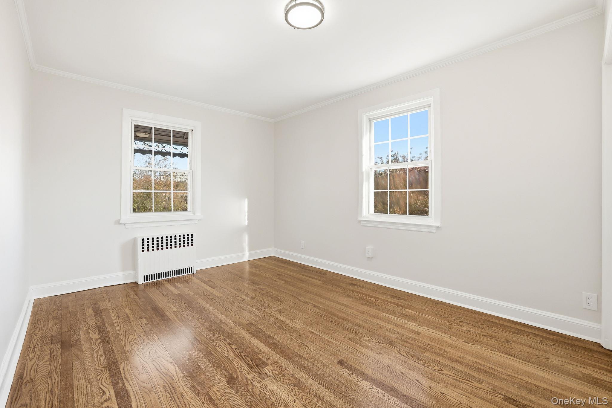 2015 Tenbroeck Avenue Bronx, NY 10461 - Photo 25 of 50 an empty room with wooden floor and windows