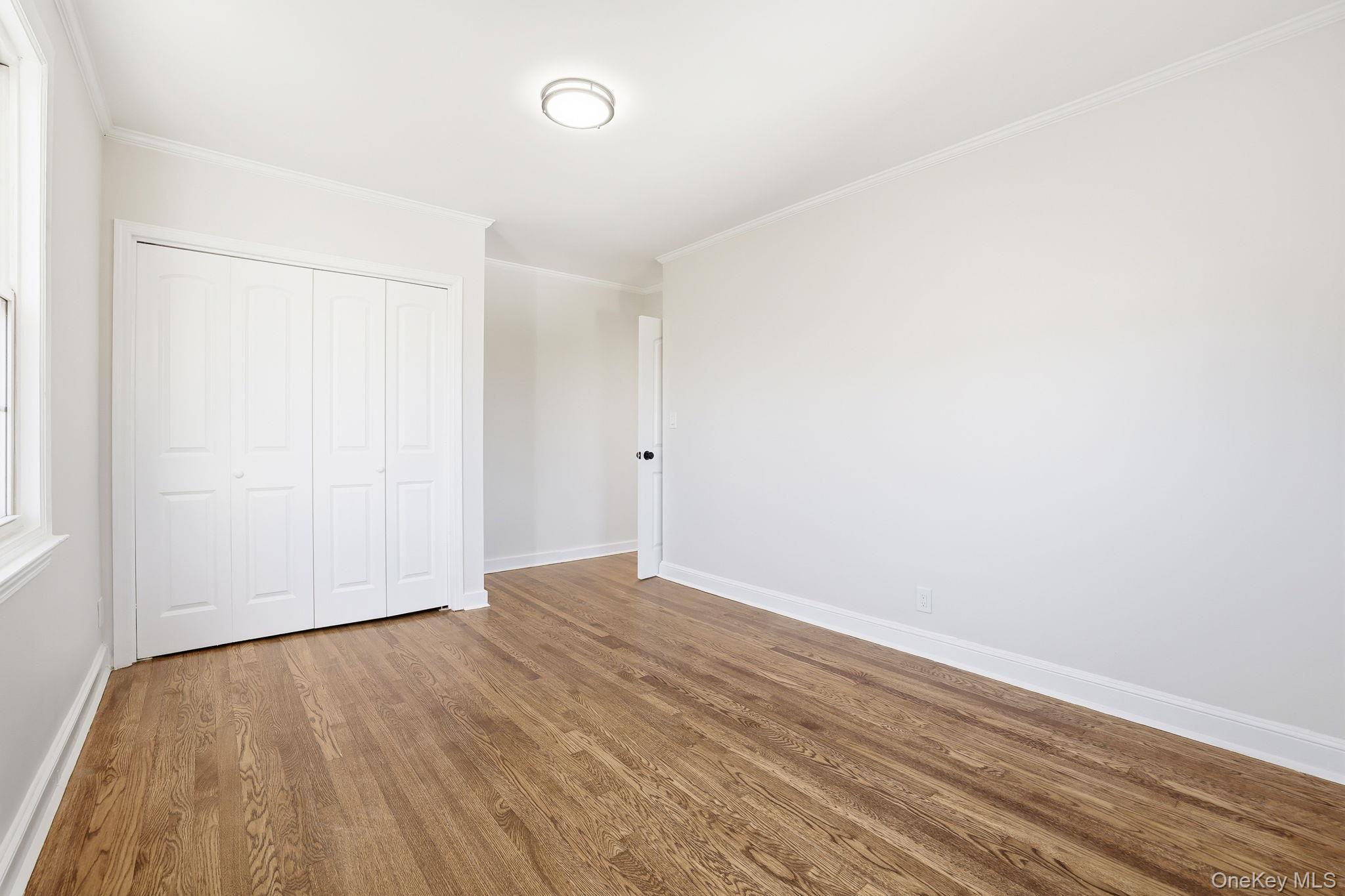 2015 Tenbroeck Avenue Bronx, NY 10461 - Photo 26 of 50 an empty room with wooden floor