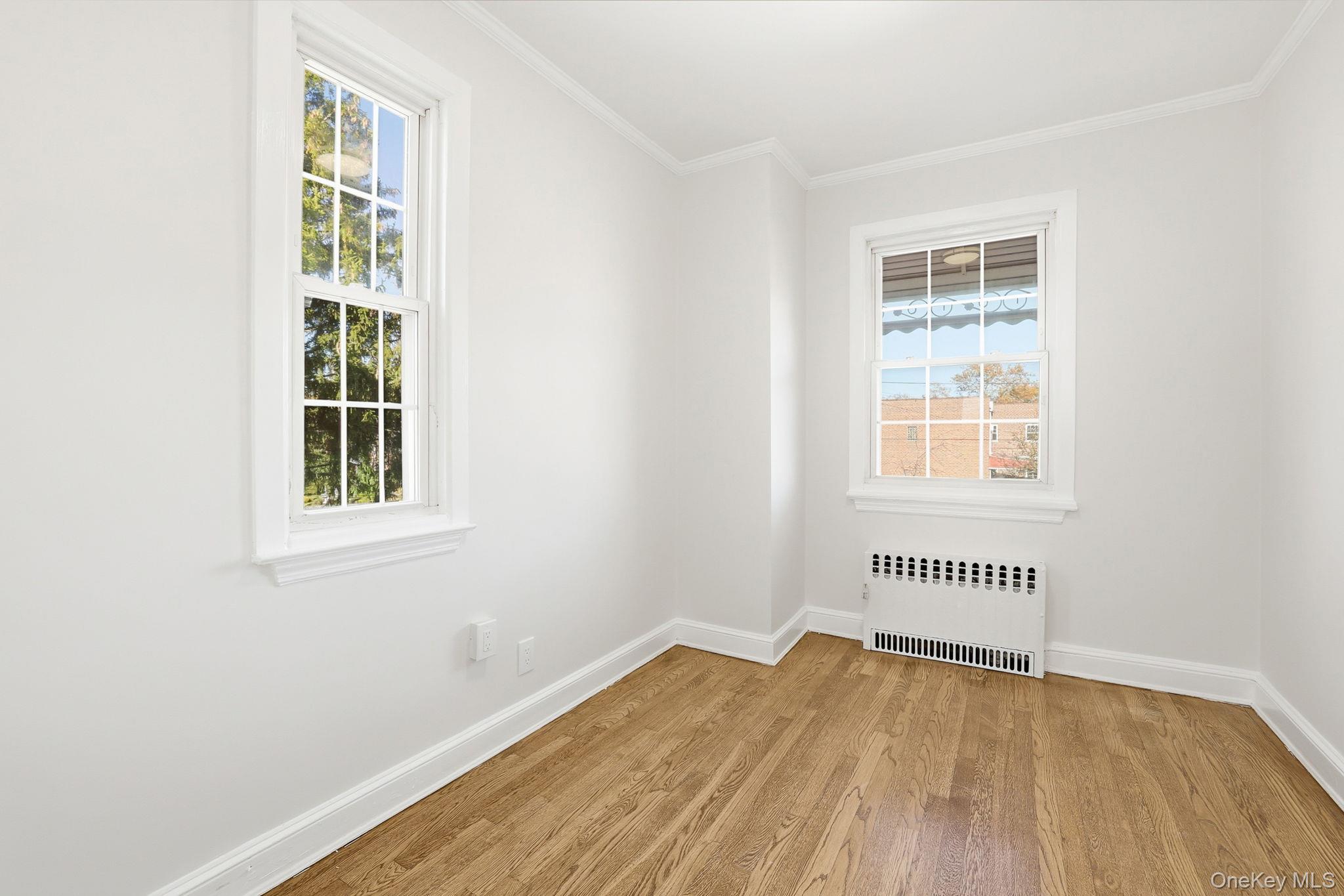 2015 Tenbroeck Avenue Bronx, NY 10461 - Photo 27 of 50 an empty room with wooden floor and windows
