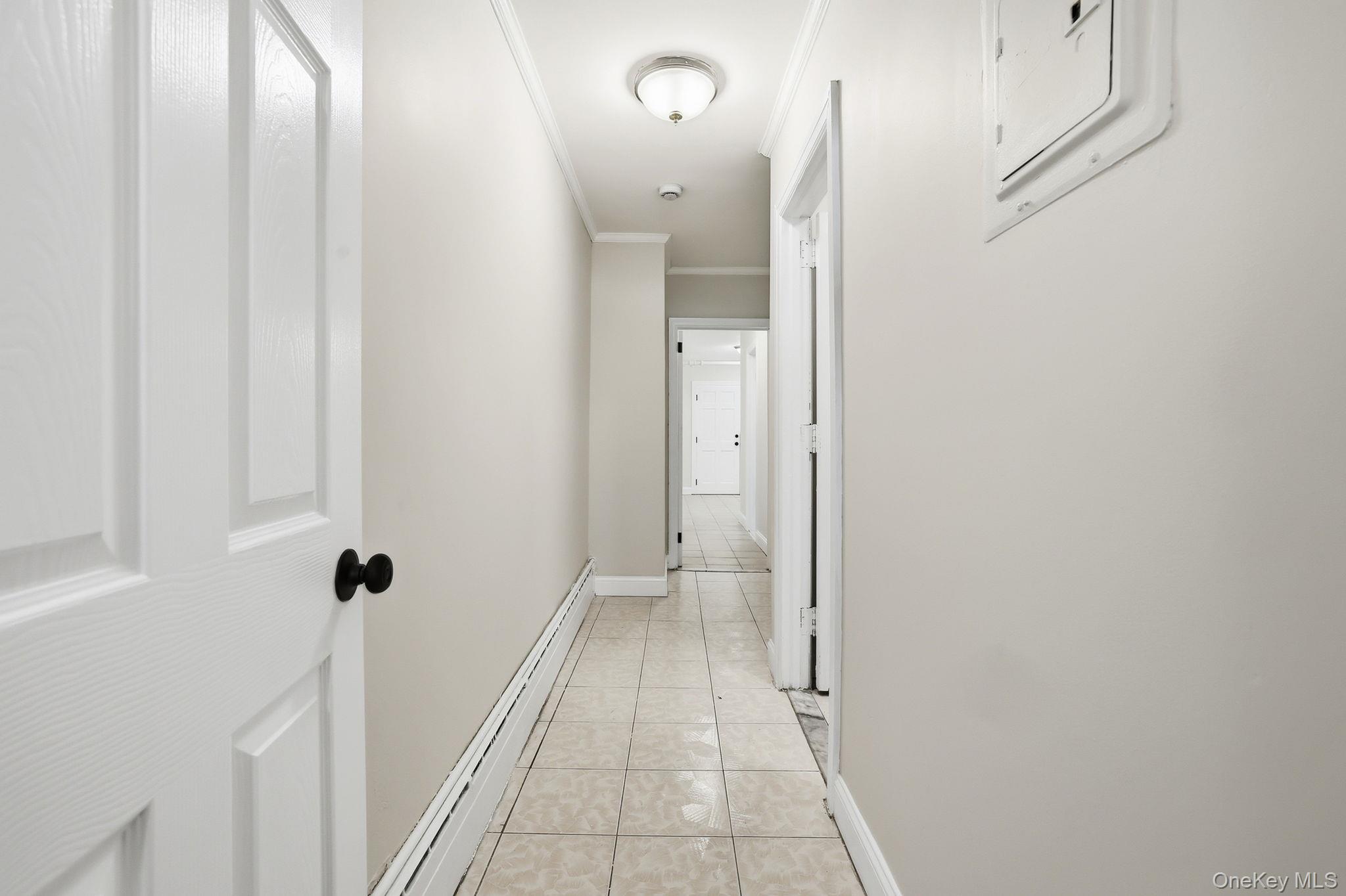 2015 Tenbroeck Avenue Bronx, NY 10461 - Photo 31 of 50 a view of a hallway with wooden floor and a bathroom