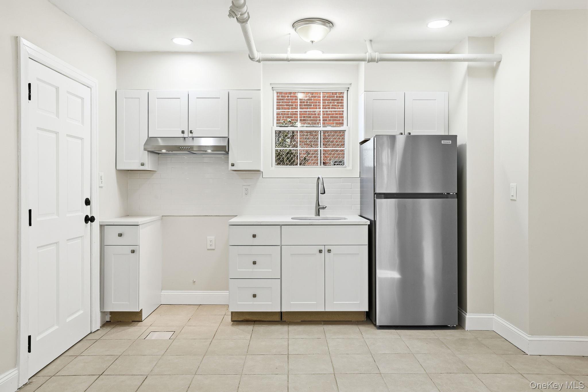 2015 Tenbroeck Avenue Bronx, NY 10461 - Photo 35 of 50 a kitchen with white cabinets and refrigerator