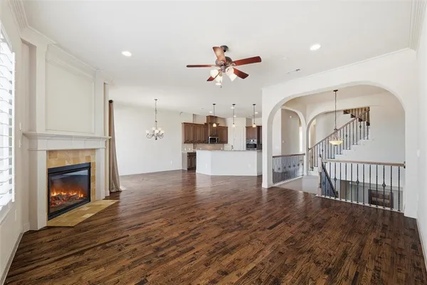 a view of empty room with fireplace and wooden floor