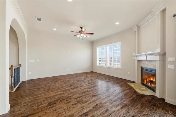 a view of an empty room with a fireplace and a window