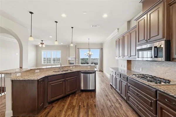 a kitchen with stainless steel appliances granite countertop a stove and a sink
