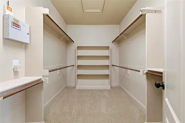 a view of walk in closet with empty racks
