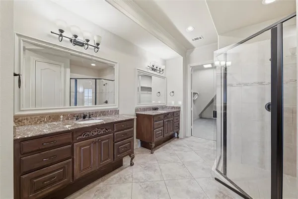 a spacious bathroom with a granite countertop sink mirror and a bathtub