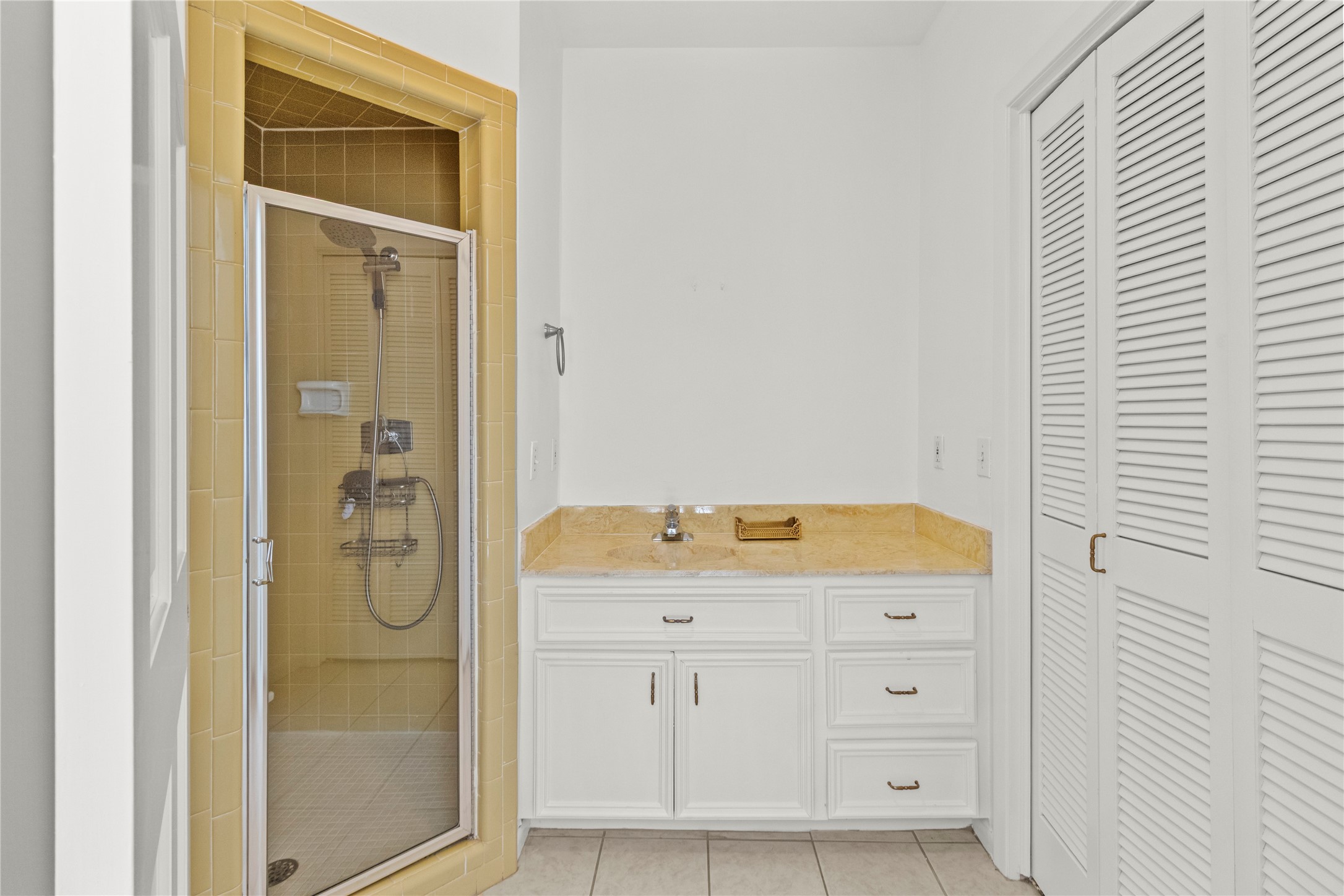 201 Vanderpool Lane, Unit 103 Houston, TX 77024 - Photo 19 of 28 a bathroom with a granite countertop sink and a mirror