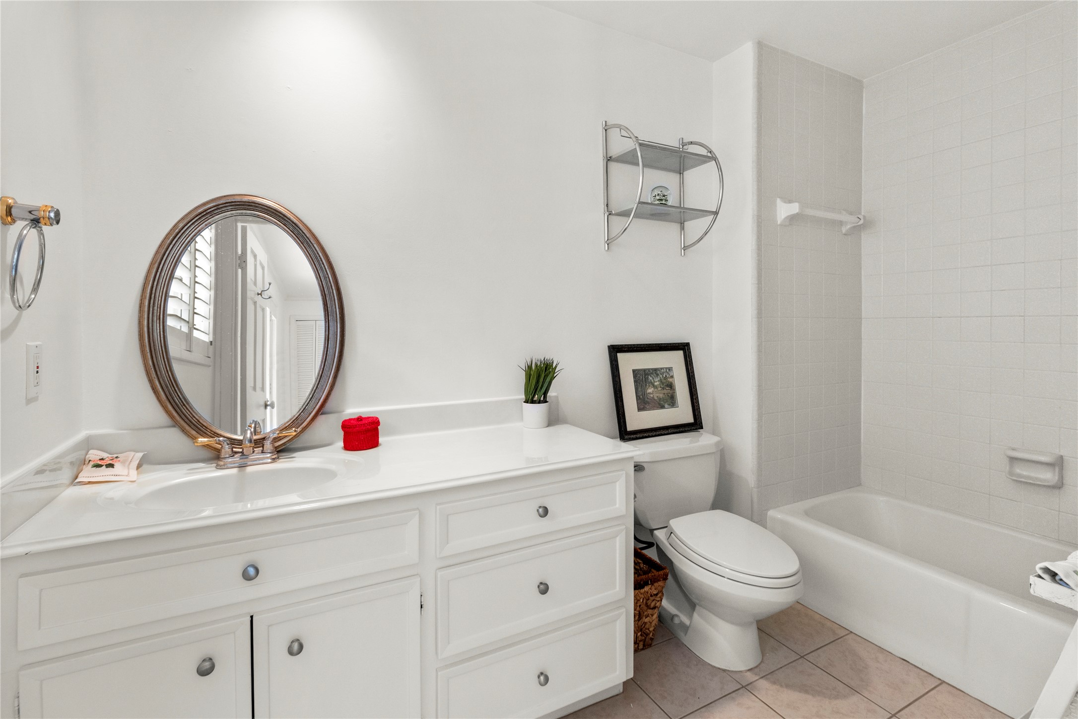 201 Vanderpool Lane, Unit 103 Houston, TX 77024 - Photo 23 of 28 a bathroom with a toilet a sink and a mirror