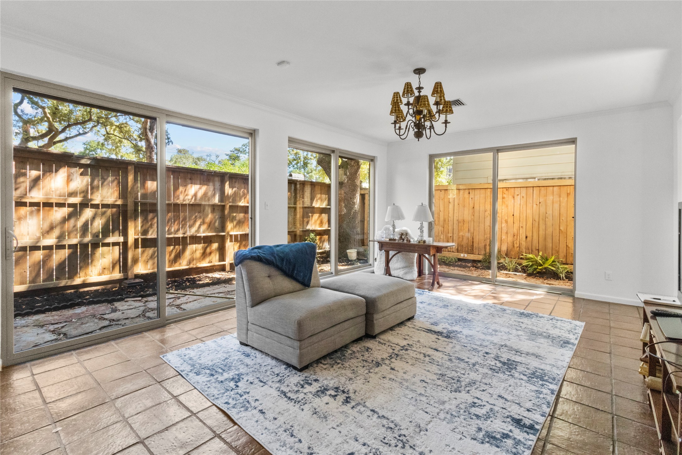201 Vanderpool Lane, Unit 103 Houston, TX 77024 - Photo 27 of 28 a living room with furniture and floor to ceiling windows