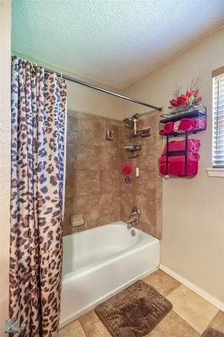 a bathroom with a bathtub and shower
