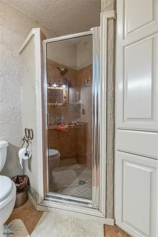 a bathroom with a glass shower door