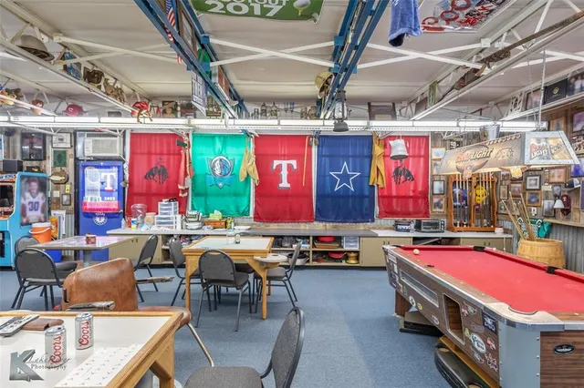 a room with stainless steel appliances kitchen island dining table and chairs