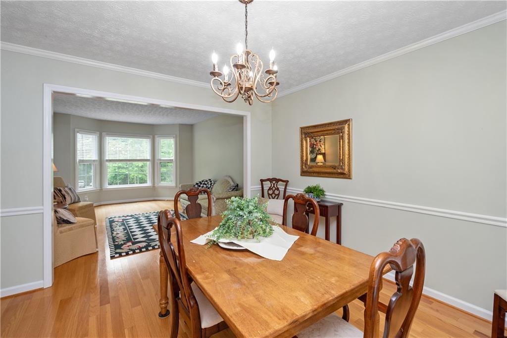 405 Ridgemont Drive Fayetteville, GA 30215 - Photo 6 of 43 a view of a dining room with furniture window and wooden floor