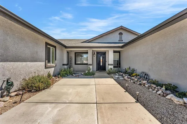 a kitchen with stainless steel appliances granite countertop a refrigerator stove top oven and sink