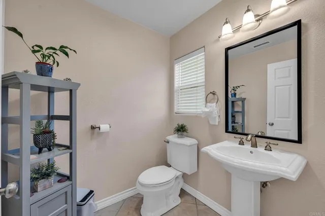 a bedroom with a bed a window and a chandelier