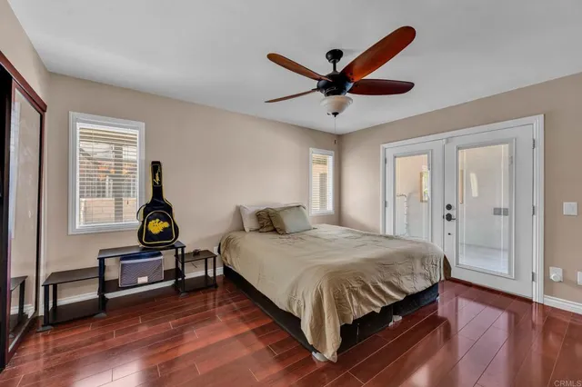 a bathroom with a granite countertop sink a large mirror and a bathtub