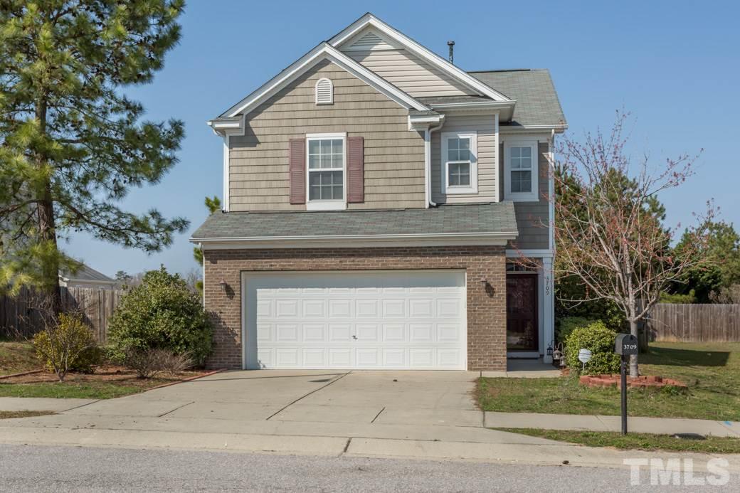 3709 Marshlane Way Raleigh, NC 27610 - Photo 1 of 9 a front view of a house with a yard and garage
