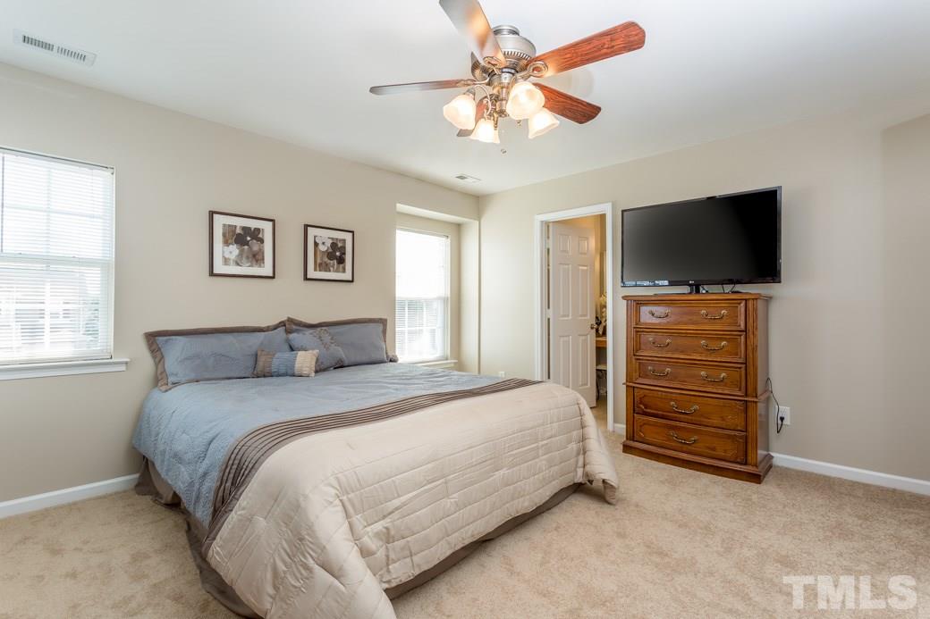 3709 Marshlane Way Raleigh, NC 27610 - Photo 5 of 9 a bedroom with a bed and a flat screen tv
