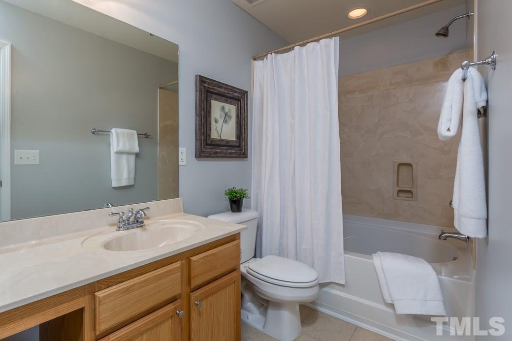 3709 Marshlane Way Raleigh, NC 27610 - Photo 6 of 9 a bathroom with a sink toilet and shower